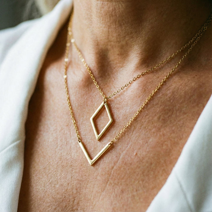 Elegant necklace with geometric V-shaped pendant. 1